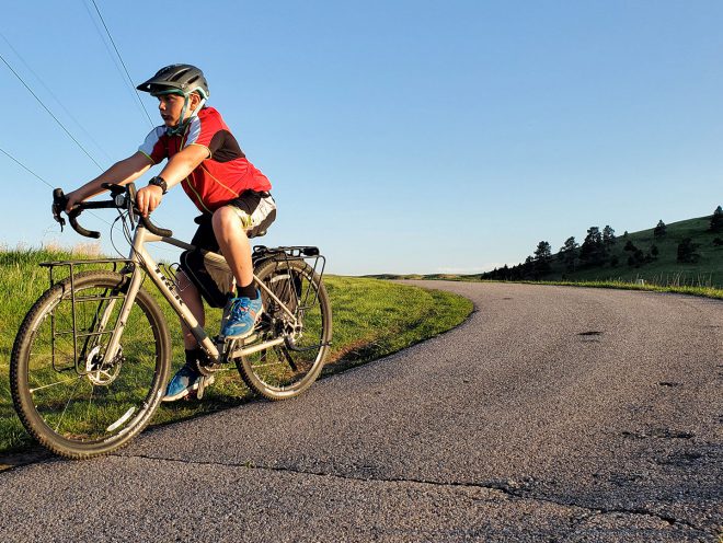 11-year-old Bodhi Linde riding a Trek 920 on a rural road.