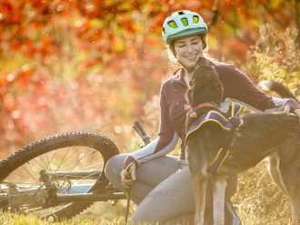 Blair Braverman disfruta de un momento con uno de sus perros en medio del hermoso follaje de otoño.