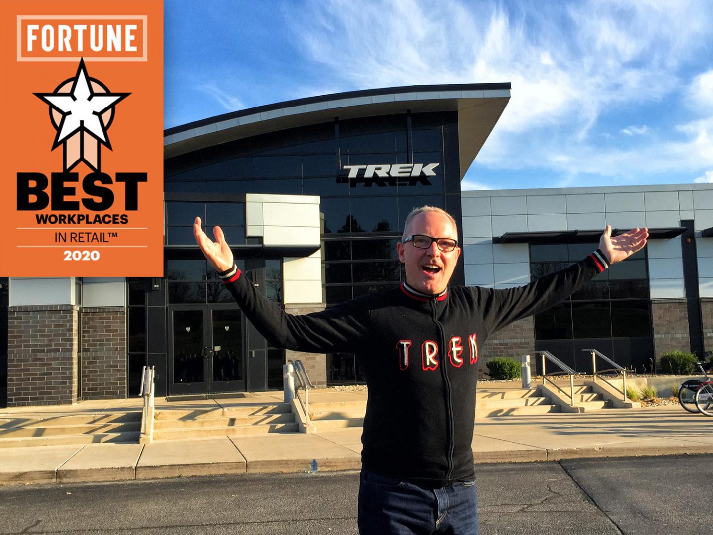 Mark Joslyn, Trek VP, outside Trek HQ with his arms spread.