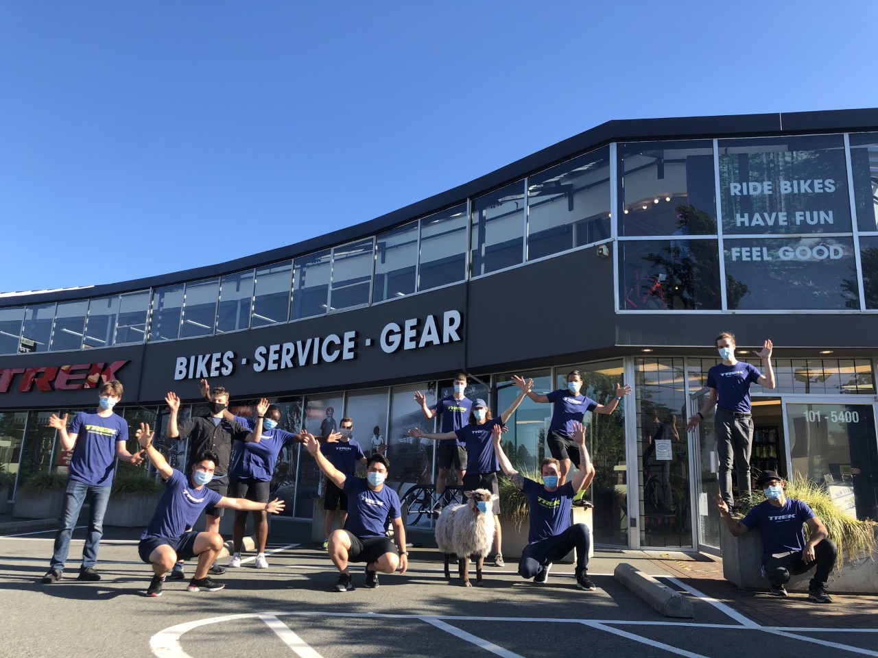 A group of Trek employees outside of a Trek retail store.