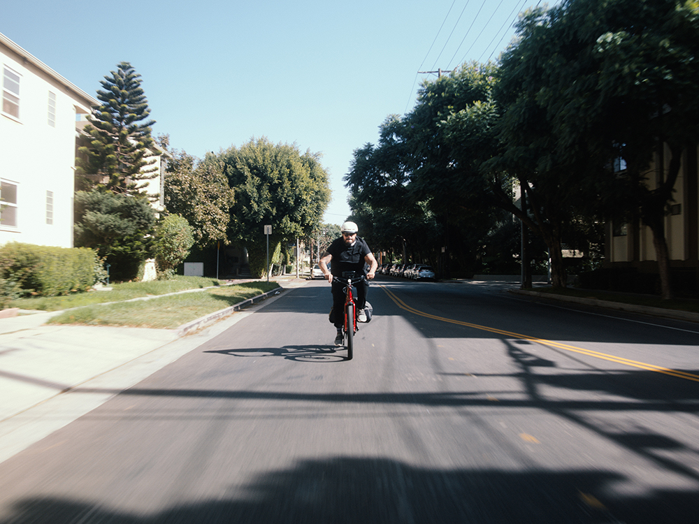 Chuck Herrera rides his Allant+ down a street.