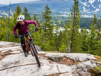 Christina Chappetta pedalling on top of a rocky climb
