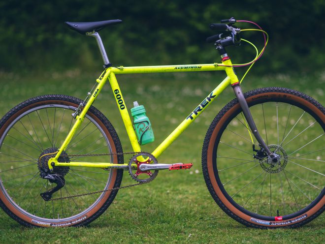 A fluorescent yellow Trek 6000 stands alone in a grassy field