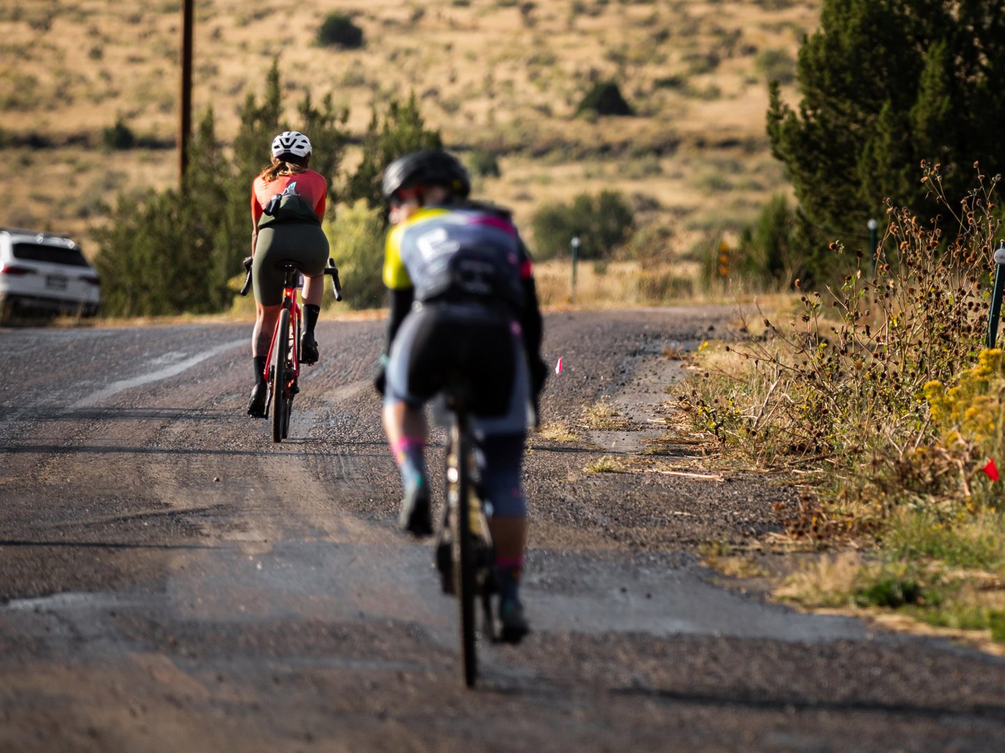 Riders on a rough pavement and gravel road