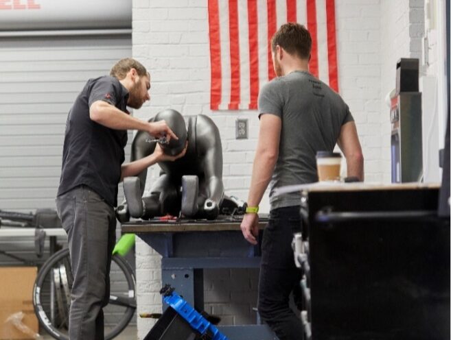 Two people fixing a mannequin