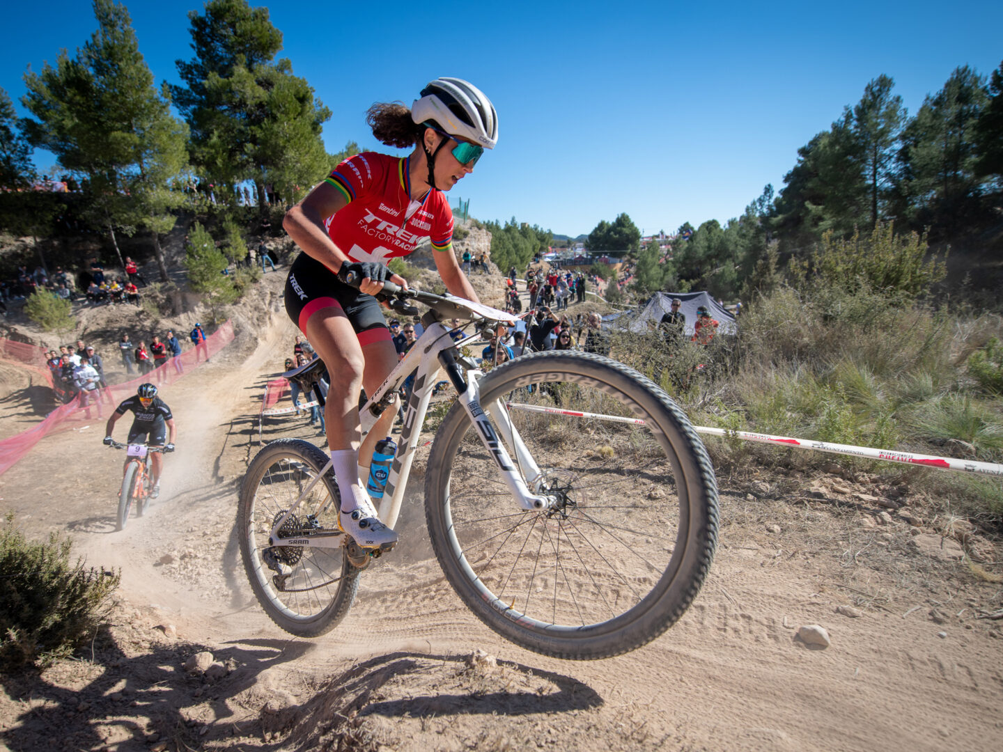 Jolanda Neff catching air over a roller while racing.