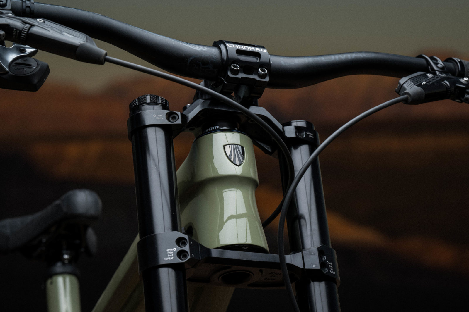 Detail image of the head tube of Brandon's green dual-crown Session.