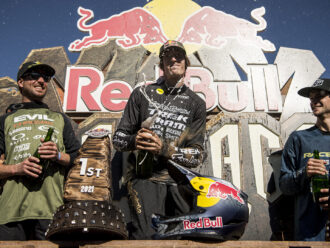 Brandon Semenuk celebrating his Red Bull Rampage 2021 win by popping champagne at the podium.