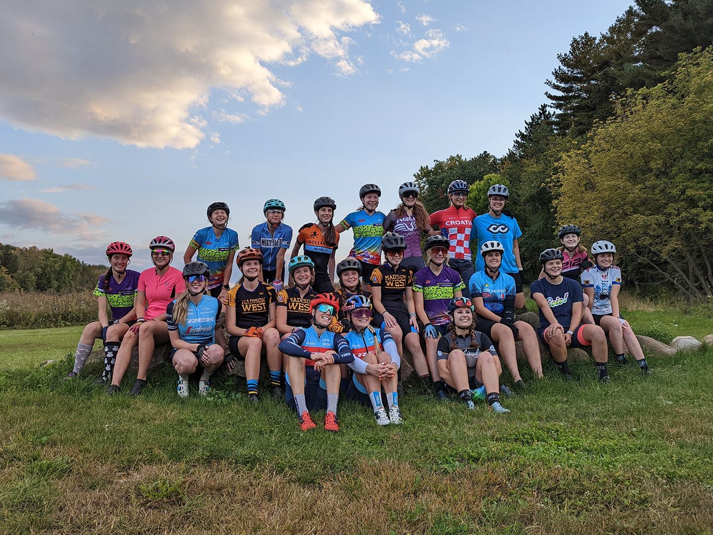 A group of GRiT riders posing at the Trek trails with Evie Richards and Madigan Munroe.