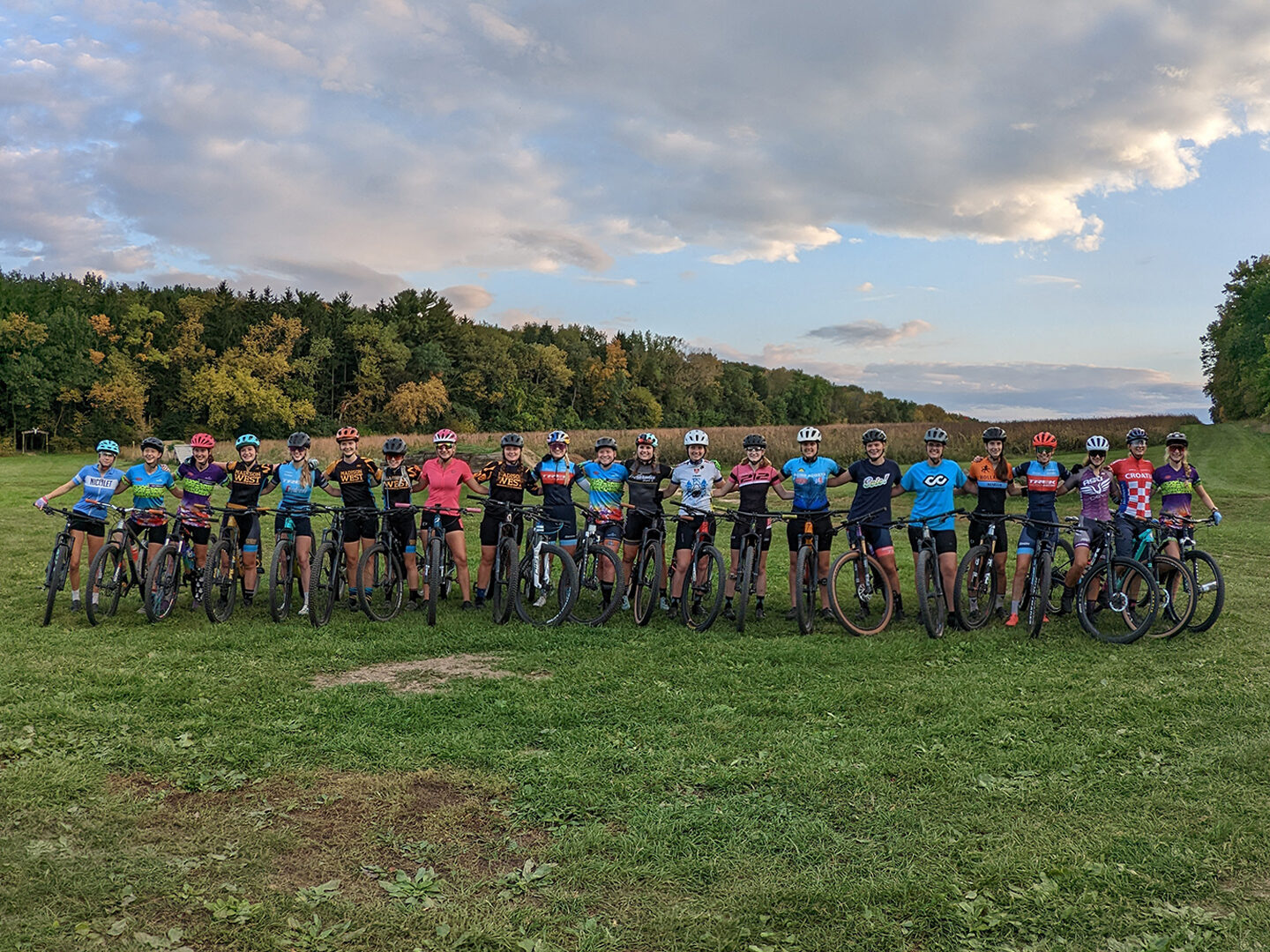 A group of GRiT riders posing at the Trek trails with Evie Richards and Madigan Munroe