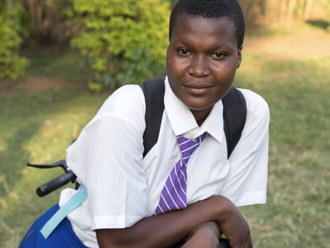 A student in her school uniform leaning over her Buffalo Bicycle.