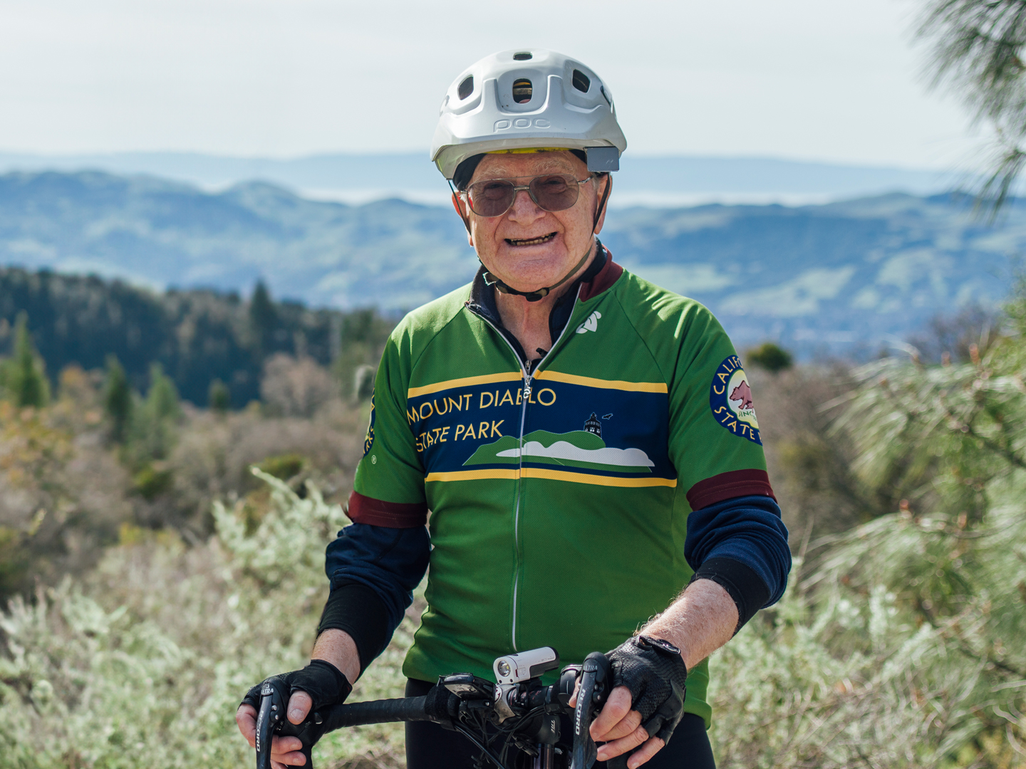 Joe Shami standing with his bike on Mount Diablo.